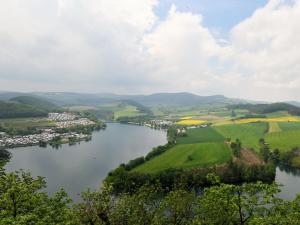a river in the middle of a valley with green fields at Ferienhaus Christa in Diemelsee