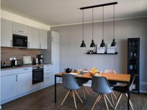 a kitchen with a wooden table and chairs at Ferienhaus Christa in Diemelsee