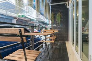 a row of tables and chairs on the side of a building at The Little Pig Sukhumvit in Bangkok