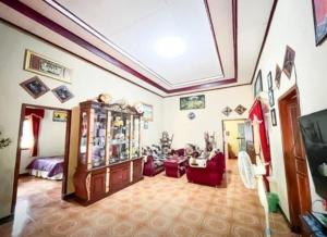 a living room with red chairs and a room with a ceiling at Penginapan,Villa dan Homestay Geopark Ciletuh in Cilowa
