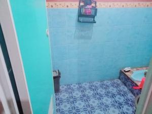 a bathroom with a shower with a blue tiled floor at Penginapan,Villa dan Homestay Geopark Ciletuh in Cilowa +29 photos