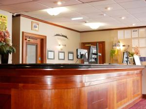 a bar in a hotel room with avertisement at Britannia Hotel Newcastle Airport in Newcastle upon Tyne