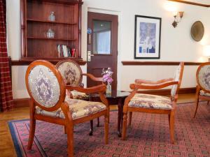 a room with four chairs and a table with at Britannia Hotel Newcastle Airport in Newcastle upon Tyne
