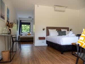 a bedroom with a bed and a table and chairs at La Coudraie - Proche de Disneyland in Montévrain