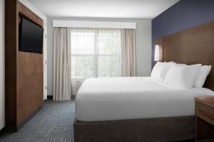 a hotel room with a large bed and a window at Residence Inn Bozeman in Bozeman