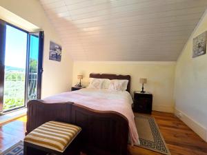 a bedroom with a large bed and a large window at Quinta da Malafaya in Nogueira +54 photos