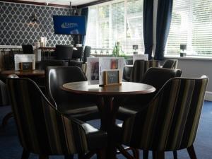 a dining room with a table and chairs at Britannia Hotel Newcastle Airport in Newcastle upon Tyne