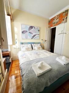 a bedroom with a large bed with two towels on it at Quinta da Malafaya in Nogueira