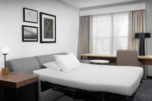 a hotel room with a bed and a couch at Residence Inn Bozeman in Bozeman