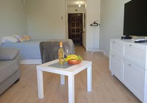 a living room with a table with a bottle on it at Estudio en Torres del Sol en lado del mar in Arona