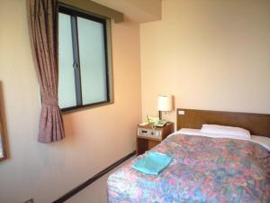 En eller flere senge i et værelse på Hotel Takamatsu Hills