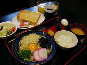 a table with a tray of food with rice and eggs at Hotel Takamatsu Hills in Takamatsu