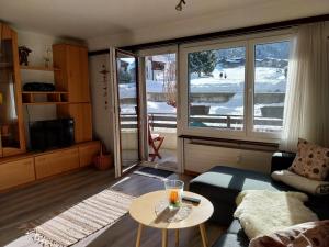 a living room with a couch and a table at Sky Haus Residence inkl parking in Täsch +1 photo
