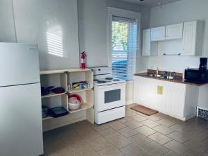 a kitchen with a white stove and a refrigerator at Entire Private STL Apartment - 51A in Carondelet