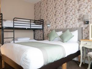 a bedroom with two bunk beds in a room at Britannia Hotel Newcastle Airport in Newcastle upon Tyne