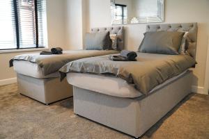 ヨークにあるModern&Luxury House Near City Centreの寝室に並んで置かれた2つのベッド