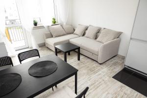 a living room with a couch and tables at Apartament Symfonia in Radom