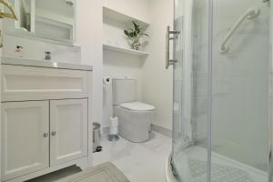 a white bathroom with a shower and a toilet at Meadowside B&B in Bunclody +25 photos