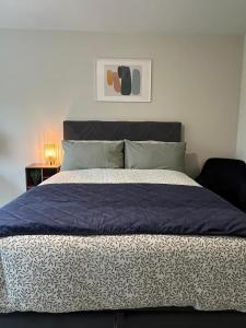 a bedroom with a bed with a blue comforter at The Matrix in Dublin