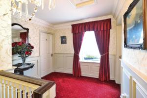 a room with a window and a red carpet at Meadowside B&B in Bunclody