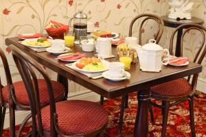a wooden table with plates of food on it at Meadowside B&B in Bunclody