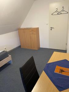 a room with a table and a cabinet and a door at Familie Alber 1P in Elze