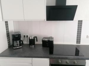 a kitchen counter with a coffee maker and a coffeemaker at Ferienwohnung II Sarrebriese in Bottmersdorf +3 photos