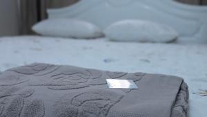a laptop sitting on top of a blanket on a bed at Койгельды 163 in Taraz