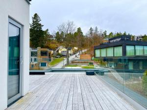 a balcony of a building with a view of a city at Exklusiv villa med sjöutsikt och egen brygga in Nacka