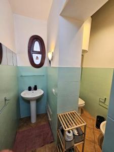 a small bathroom with a sink and a window at Happie Casa Il Capo & La Cattedrale in Palermo +20 photos