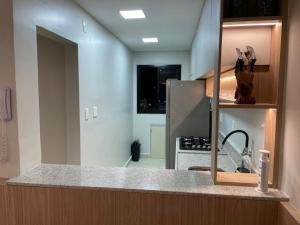 a kitchen with a sink and a counter top at Apto de frente ao mar da Praia de Itaparica ES in Itaparica +15 photos