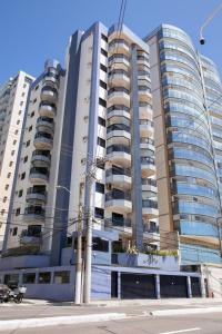 two tall buildings in a city with a street at Apto de frente ao mar da Praia de Itaparica ES in Itaparica