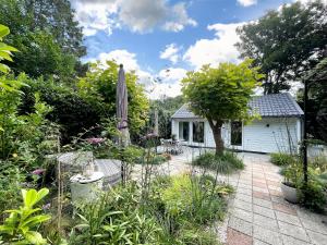 a garden in front of a white house at Duinstudio Bergen in Bergen +115 photos