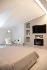 a bedroom with a bed and a tv and a fireplace at Hotel Ristorante Europa in Venticano