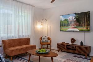 a living room with a couch and a table at The Monterey -- Private Pool & Grill - 4 KING Beds in Gainesville