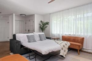 a bedroom with a large bed and a chair at The Monterey -- Private Pool & Grill - 4 KING Beds in Gainesville +53 photos