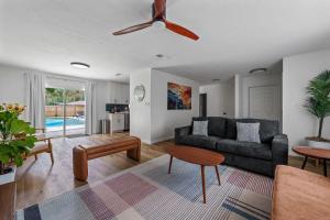 a living room with a couch and a table at The Monterey -- Private Pool & Grill - 4 KING Beds in Gainesville