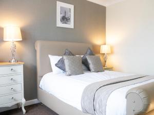 a bedroom with a white bed with two lamps at Britannia Hotel Newcastle Airport in Newcastle upon Tyne