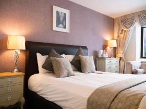 a bedroom with a bed with two night stands and two lamps at Britannia Hotel Newcastle Airport in Newcastle upon Tyne +37 photos