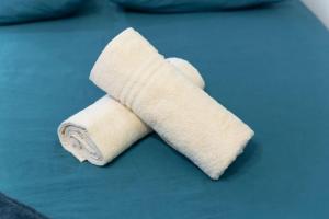 a roll of white toilet paper sitting on a bed at Le Clichy Chic in Clichy