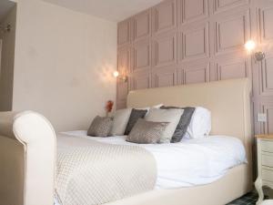 a bedroom with a bed with white sheets and pillows at Britannia Hotel Newcastle Airport in Newcastle upon Tyne