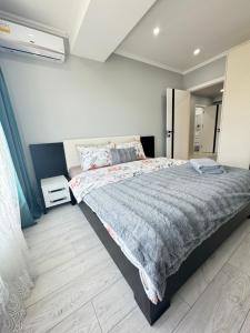 a bedroom with a large bed and a mirror at Near Airport Cozy Apartment in Codru