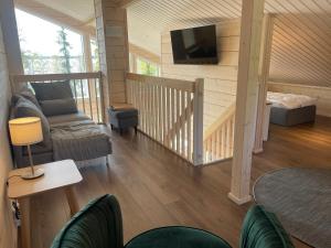 a living room with a couch and a flat screen tv at Miilu Resort in Ylläsjärvi