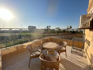 a patio with a table and chairs on a balcony at Elite House الصفوة للشقق الفندقية in 6th Of October