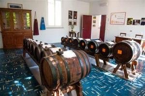 a row of wine barrels in a room at B&B Luna in Castelvetro di Modena