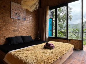 a bedroom with a bed in a room with windows at HOMESTAY ĐỐM HOUSE in Hoat
