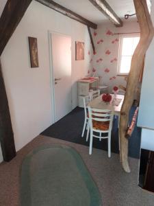 a room with a table and chairs in a room at TheBackyard in Osterwieck +23 photos