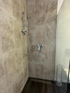 a shower with a hose in a bathroom at Rosemarin Green in Koper