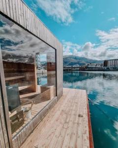 a house on a dock with a view of the water at Apartment with Loft & Window Balcony, Free parking in Bergen