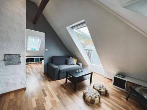 a living room with a couch and a table at Apartment with Loft & Window Balcony, Free parking in Bergen